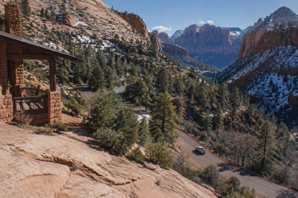 Winding two-lane highway cutting through red rock cliffs and ponderosa forest on the Zion to Bryce route