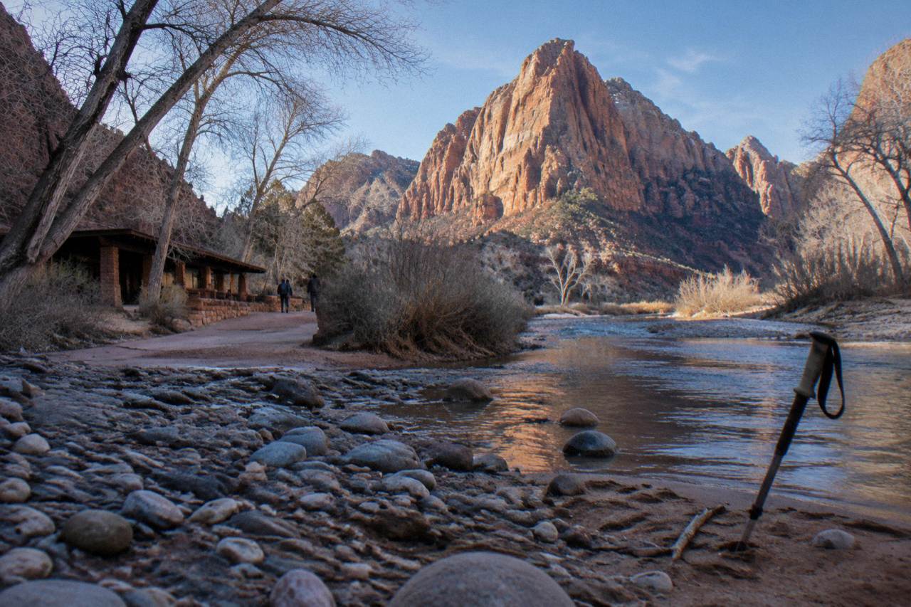 Red rock canyon walls above a sandy river corridor in Zion National Park