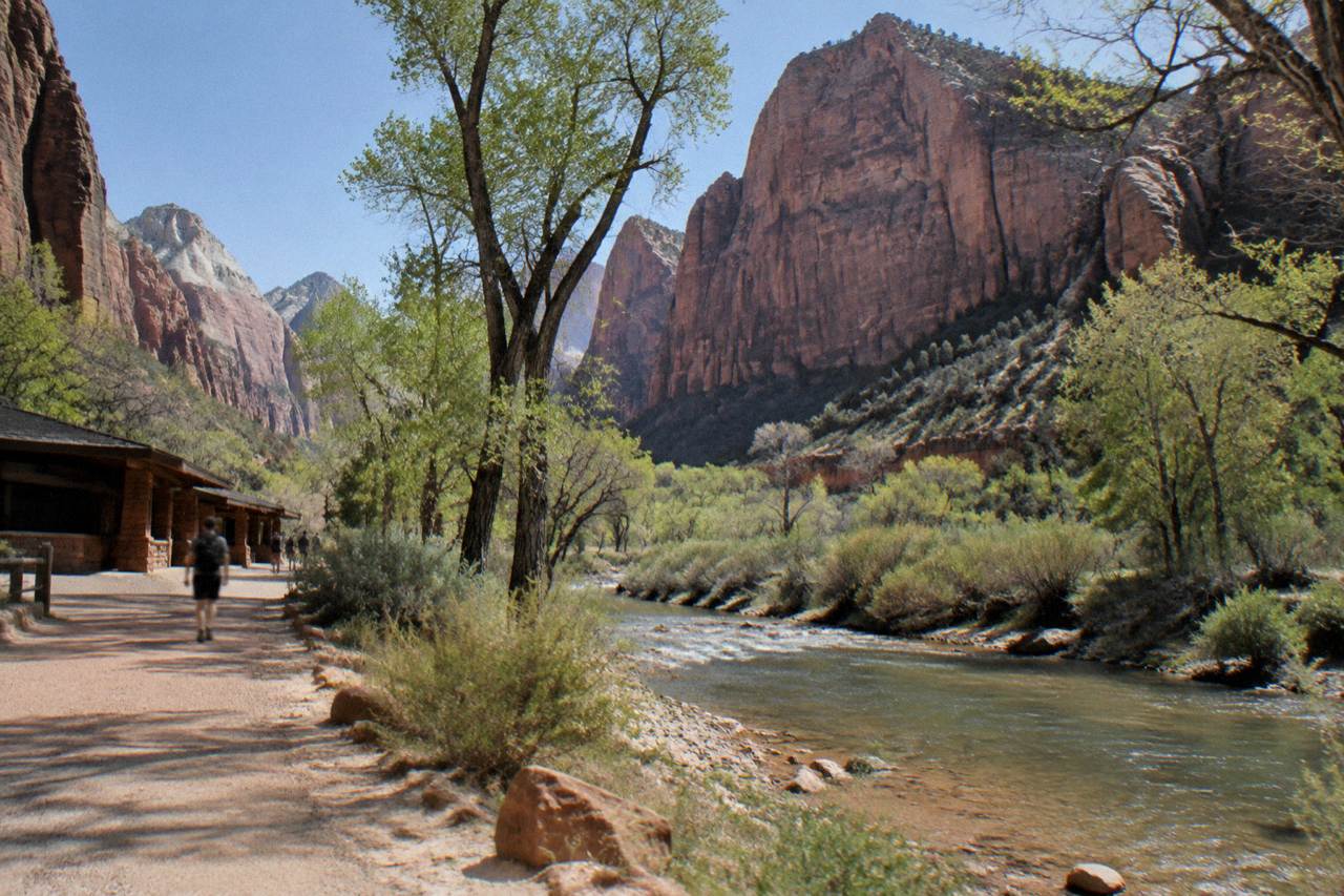 Red rock canyon walls rising above a sandy valley in southern Utah