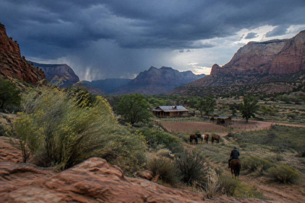 Dark monsoon storm clouds building over red rock canyon walls