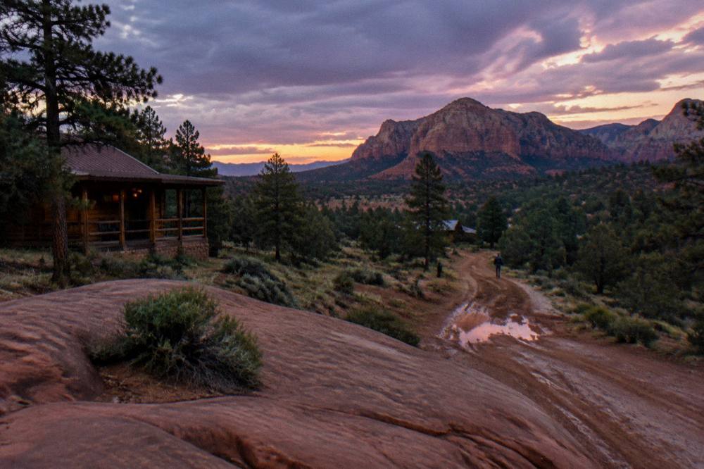 A dirt road leading toward red rock buttes on the east side of Zion at dusk